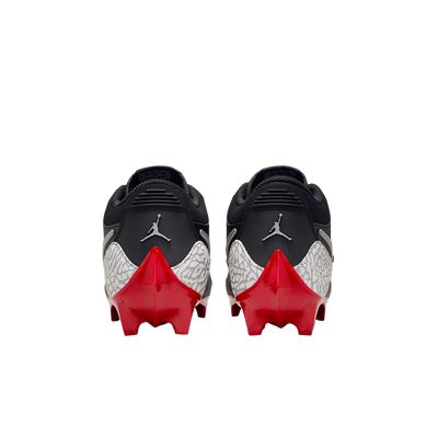 Jordan Legacy 312 Low TD cleats in black and cement grey, rear heel view of the pair with red outsole